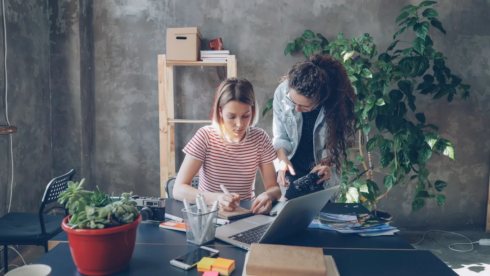 Two creatives finishing a project together in a studio
